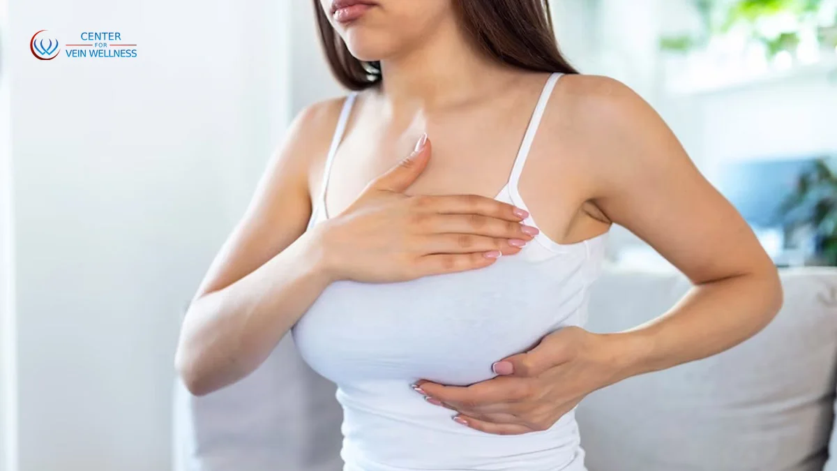 Woman experiencing breast tenderness and visible veins before her period due to hormonal changes